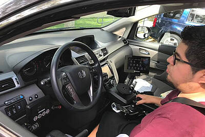 Man driving with drive-by-wire system for disabled drivers